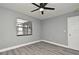 Comfortable bedroom featuring new gray vinyl floors, fresh paint, and contemporary ceiling fan at 5805 Hutton Dr, Orlando, FL 32808