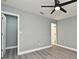 This spacious bedroom has new flooring, a ceiling fan, fresh paint, and two entry doors at 5805 Hutton Dr, Orlando, FL 32808