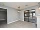 Bright dining room with new light fixture, gray vinyl floors, and sliding glass doors to the backyard at 5805 Hutton Dr, Orlando, FL 32808