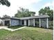Charming single-story home with stone details and a well-maintained lawn at 5805 Hutton Dr, Orlando, FL 32808