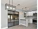 Open kitchen with stainless steel appliances, breakfast bar, updated cabinets, and sliding doors to the lanai at 5805 Hutton Dr, Orlando, FL 32808
