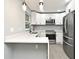 Beautiful kitchen features white cabinets, stainless steel appliances, quartz countertops, and a modern faucet at 5805 Hutton Dr, Orlando, FL 32808