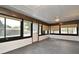 Large, enclosed lanai with neutral paint, many windows, and a door leading to the backyard at 5805 Hutton Dr, Orlando, FL 32808