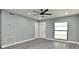 Welcoming living room featuring new gray vinyl floors, fresh paint, and contemporary ceiling fan at 5805 Hutton Dr, Orlando, FL 32808
