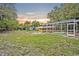 Wide angle view of backyard including a screened pool and horse stables at 595 Seminole Woods Blvd, Geneva, FL 32732