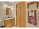 Cozy bathroom featuring granite counters, wooden cabinets and neutral walls at 595 Seminole Woods Blvd, Geneva, FL 32732