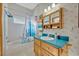 Charming bathroom with sea-themed decor, a combination tub and shower, and a mirrored medicine cabinet at 595 Seminole Woods Blvd, Geneva, FL 32732