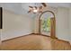 Spacious bedroom with hardwood flooring, ceiling fan and a window with light-filtering curtains at 595 Seminole Woods Blvd, Geneva, FL 32732