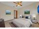 Carpeted bedroom with modern furnishings, featuring neutral-toned bedding, side tables, and decorative wall art at 595 Seminole Woods Blvd, Geneva, FL 32732