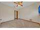 Empty carpeted bedroom featuring a ceiling fan and doorway at 595 Seminole Woods Blvd, Geneva, FL 32732