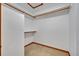 Walk-in closet with ample shelving, rods, and neutral carpeting at 595 Seminole Woods Blvd, Geneva, FL 32732