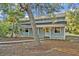 Charming home featuring a covered porch and natural surroundings, offering a tranquil living experience at 595 Seminole Woods Blvd, Geneva, FL 32732