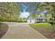 Lovely home featuring a two-car garage, a long driveway, and lush greenery, offering a private setting at 595 Seminole Woods Blvd, Geneva, FL 32732