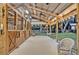 Spacious, covered horse stables including rocking chairs for relaxing at 595 Seminole Woods Blvd, Geneva, FL 32732