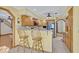 Open kitchen with granite counters, wooden cabinets and breakfast bar with seating at 595 Seminole Woods Blvd, Geneva, FL 32732