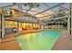 Inviting screened-in pool with an attached spa and beautiful backyard at dusk at 595 Seminole Woods Blvd, Geneva, FL 32732