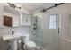 Modern bathroom featuring black fixtures, tile walls, and glass enclosed shower stall at 6 S Lakewood Dr, Orlando, FL 32803