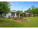 Exterior view of a single-story home featuring a well-kept lawn and tropical landscaping at 6 S Lakewood Dr, Orlando, FL 32803