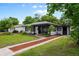Cozy home with a welcoming front yard, lovely landscaping, and a red brick walkway at 6 S Lakewood Dr, Orlando, FL 32803