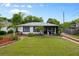 Charming single-story home with a well-manicured front yard and decorative landscaping at 6 S Lakewood Dr, Orlando, FL 32803