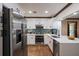 Modern kitchen with stainless steel appliances, white cabinetry, and quartz countertops at 6 S Lakewood Dr, Orlando, FL 32803