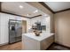 Eat-in kitchen featuring stainless steel appliances, island with sink and white cabinetry at 6 S Lakewood Dr, Orlando, FL 32803