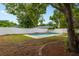 Backyard pool surrounded by lush trees and grass, perfect for summer fun at 6 S Lakewood Dr, Orlando, FL 32803