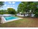 Inviting pool and backyard with lush landscaping and a classic white house exterior at 6 S Lakewood Dr, Orlando, FL 32803