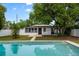 Backyard pool view with house and lush landscaping, a perfect retreat at 6 S Lakewood Dr, Orlando, FL 32803