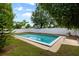 Refreshing pool surrounded by a spacious, green yard with a white fence for privacy at 6 S Lakewood Dr, Orlando, FL 32803
