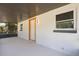 This porch features white walls, a grey-colored ceiling, a window, and a door leading to the outside at 612 Florida Ave, St Cloud, FL 34769