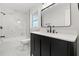 This stylish bathroom features modern black fixtures, marble-look shower walls, and a white vanity at 612 Florida Ave, St Cloud, FL 34769
