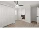 This room has vinyl flooring, ceiling fan, closet, and view into another room, potential bedroom at 612 Florida Ave, St Cloud, FL 34769