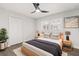 This is a modern bedroom with light-colored walls, wood-look flooring, and a ceiling fan at 612 Florida Ave, St Cloud, FL 34769