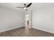 Empty bedroom showcasing light-colored walls, vinyl floor, and a view into the kitchen through the doorway at 612 Florida Ave, St Cloud, FL 34769