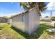 Exterior of a shed-style building in a backyard, complemented by lush green grass at 612 Florida Ave, St Cloud, FL 34769