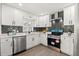 Modern kitchen with stainless steel appliances, sleek countertops, and stylish tile backsplash at 612 Florida Ave, St Cloud, FL 34769