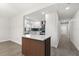 Modern kitchen view highlighting stylish island, sleek cabinetry, and open flow to adjacent living spaces at 612 Florida Ave, St Cloud, FL 34769