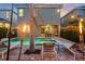 The backyard has a sparkling pool, spa, tiki torches, and lounge chairs for relaxation and entertainment at 640 Lasso Dr, Kissimmee, FL 34747