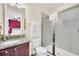 Bathroom with granite counters, updated fixtures, and glass-enclosed shower viewed from bedroom at 640 Lasso Dr, Kissimmee, FL 34747