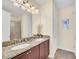 Double vanity bathroom featuring granite countertops, modern lighting, and ample space at 640 Lasso Dr, Kissimmee, FL 34747