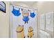 A view of a bathroom with a Minions-themed shower curtain at 640 Lasso Dr, Kissimmee, FL 34747