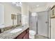 Modern bathroom featuring a granite countertop, walk-in shower, and neutral color palette at 640 Lasso Dr, Kissimmee, FL 34747