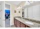 Well lit bathroom featuring a double vanity, granite countertops, and cartoon artwork at 640 Lasso Dr, Kissimmee, FL 34747
