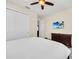 Bright bedroom featuring a ceiling fan, closet, and a TV mounted on the wall for entertainment at 640 Lasso Dr, Kissimmee, FL 34747