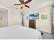 Inviting bedroom includes a TV, closet, dresser, and a view of the hallway at 640 Lasso Dr, Kissimmee, FL 34747