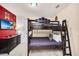 Comfortable bedroom with a wooden bunk bed and a TV screen on the red wall at 640 Lasso Dr, Kissimmee, FL 34747