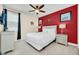 Bedroom with red accent wall, nautical decor, and neutral furnishings at 640 Lasso Dr, Kissimmee, FL 34747