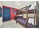 The red themed bedroom offers a wooden bunk bed perfect for a getaway at 640 Lasso Dr, Kissimmee, FL 34747