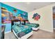 Whimsical bedroom with ocean themed wall art, two beds, and dark furnishings at 640 Lasso Dr, Kissimmee, FL 34747